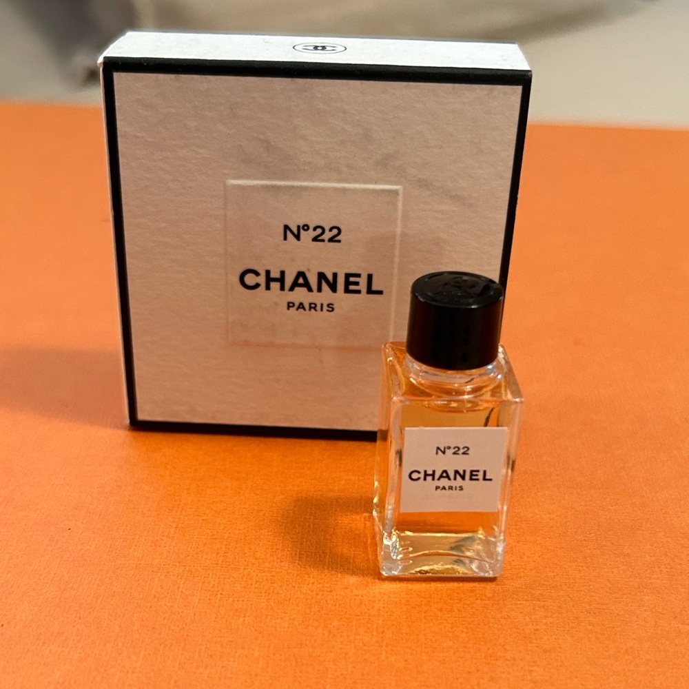 CHANEL N°22 Mini Perfume Bottle with White Box on Orange Surface
